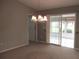 Dining room featuring carpet flooring, neutral walls, and sliding glass doors at 11495 Sw 138Th Ln, Dunnellon, FL 34432