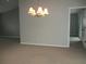 Spacious dining room with neutral paint, plush carpet, and modern light fixture at 11495 Sw 138Th Ln, Dunnellon, FL 34432