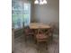 Cozy dining table with seating for four, situated near a large window for bright, sunny meals at 11495 Sw 138Th Ln, Dunnellon, FL 34432