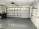 Spacious two car garage with epoxy flooring and storage cabinets at 11495 Sw 138Th Ln, Dunnellon, FL 34432