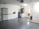 Garage with water heater, storage shelves and cabinets, and epoxy flooring at 11495 Sw 138Th Ln, Dunnellon, FL 34432