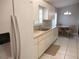 Kitchen featuring white cabinets and appliances including a dishwasher and side-by-side refrigerator/freezer at 11495 Sw 138Th Ln, Dunnellon, FL 34432
