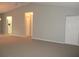 Neutral living room featuring neutral paint, carpeted floors, 2 closets and views of the kitchen at 11495 Sw 138Th Ln, Dunnellon, FL 34432