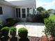 Back patio area with pavers and manicured landscaping at 11495 Sw 138Th Ln, Dunnellon, FL 34432