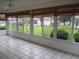 Enclosed sunroom with tile flooring, floor-to-ceiling windows providing plenty of natural light, and scenic views at 11495 Sw 138Th Ln, Dunnellon, FL 34432