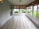Bright sunroom featuring tile floors, multiple windows with custom blinds and a ceiling fan at 11495 Sw 138Th Ln, Dunnellon, FL 34432