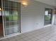 View of the sunroom with large sliding doors and neutral tile flooring and views of the yard at 11495 Sw 138Th Ln, Dunnellon, FL 34432