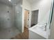 Bathroom featuring a glass-enclosed shower, double sink vanity and linen closet at 11555 Sw 59Th Ter, Ocala, FL 34476