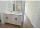 Bathroom featuring a double vanity, modern fixtures and tile flooring at 11555 Sw 59Th Ter, Ocala, FL 34476
