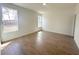 A bright bedroom with two windows and light, wood-look tile flooring at 11555 Sw 59Th Ter, Ocala, FL 34476