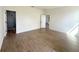 Spacious bedroom with wood-look tile flooring and access to the bathroom at 11555 Sw 59Th Ter, Ocala, FL 34476