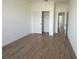A clean bedroom showcases its wood-look tile floors and closet with white sliding doors at 11555 Sw 59Th Ter, Ocala, FL 34476