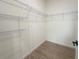 Walk-in closet featuring shelving and wood-look tile flooring at 11555 Sw 59Th Ter, Ocala, FL 34476