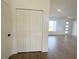 Bright entryway featuring wood-look tile floors, a closet, and an open view into the living area at 11555 Sw 59Th Ter, Ocala, FL 34476