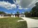 Charming single-story home featuring a gray roof, gray trim and an attached one car garage at 11555 Sw 59Th Ter, Ocala, FL 34476