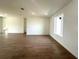 Bright, open living room featuring stylish wood-look tile flooring and recessed lighting at 11555 Sw 59Th Ter, Ocala, FL 34476