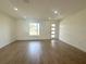 Spacious living room showcasing the modern flooring, bright lighting, and neutral paint scheme at 11555 Sw 59Th Ter, Ocala, FL 34476