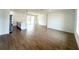 Open-concept living space with wood-look tile, island kitchen, and sliding glass doors to the backyard at 11555 Sw 59Th Ter, Ocala, FL 34476