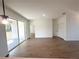 Bright living space featuring sliding glass doors to the patio and modern wood-look flooring at 11555 Sw 59Th Ter, Ocala, FL 34476