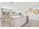 Modern kitchen with an island overlooking a dining area and great views of the outdoors at 13782 Sw 40Th Avenue Rd, Ocala, FL 34473
