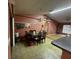 The dining room area has a table and chairs beneath a chandelier at 15115 Se 94Th Ct, Summerfield, FL 34491