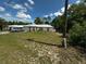 This home features a metal roof, green lawn and a driveway with parking at 15115 Se 94Th Ct, Summerfield, FL 34491