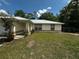 A charming home with a metal roof and green lawn, set in a quiet neighborhood at 15115 Se 94Th Ct, Summerfield, FL 34491