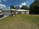 Charming single-story home featuring a metal roof and well-maintained lawn at 15115 Se 94Th Ct, Summerfield, FL 34491