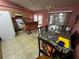 View of a bright kitchen and dining area with a breakfast bar and lots of counter space at 15115 Se 94Th Ct, Summerfield, FL 34491