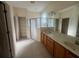 Bathroom with dual sinks, walk-in shower, and tiled floor at 1703 Sanderling St, The Villages, FL 32162