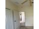 This room offers neutral paint, a ceiling fan, and a view into other rooms of the house at 1703 Sanderling St, The Villages, FL 32162