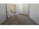 Carpeted room has an open double doorway leading to other rooms in the home at 1703 Sanderling St, The Villages, FL 32162