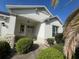 Welcoming home entrance featuring meticulously maintained landscaping and a charming, covered porch at 1703 Sanderling St, The Villages, FL 32162