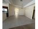 Spacious living room with neutral tile flooring and elegant chandelier at 1703 Sanderling St, The Villages, FL 32162