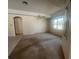 Large main bedroom has an en suite bathroom, large windows, and a ceiling fan at 1703 Sanderling St, The Villages, FL 32162