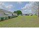 The backyard with lush green grass and minimal foliage, a canvas for personalization at 17475 Se 107Th Ct, Summerfield, FL 34491