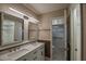 Bathroom features a double sink vanity with marble countertop and a glass-enclosed walk-in shower at 17475 Se 107Th Ct, Summerfield, FL 34491