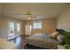 Comfortable bedroom features wood floors, ceiling fan, and French doors to bring in ample natural light at 17475 Se 107Th Ct, Summerfield, FL 34491