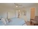 Carpet free bedroom with fan, walk-in closet, view to kitchen and natural light at 17475 Se 107Th Ct, Summerfield, FL 34491