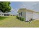 Home exterior showcasing landscaped yard, siding, and a well-maintained lawn at 17475 Se 107Th Ct, Summerfield, FL 34491