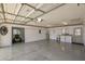 View of spacious garage with epoxy floors, laundry, shelving, and electric vehicle charger at 17475 Se 107Th Ct, Summerfield, FL 34491