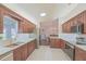 Stylish kitchen with stainless steel appliances, granite countertops, ample cabinet space and a skylight at 17475 Se 107Th Ct, Summerfield, FL 34491