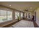 Bright and airy living area featuring floor to ceiling windows, wood floors and ceiling fan at 17475 Se 107Th Ct, Summerfield, FL 34491