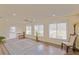 Spacious living room features multiple windows with wood floors, ceiling fan and recessed lighting at 17475 Se 107Th Ct, Summerfield, FL 34491