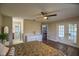 Spacious main bedroom with hardwood floors, double doors leading to a balcony and an ensuite bathroom at 17475 Se 107Th Ct, Summerfield, FL 34491
