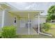 Cozy covered back patio features seating and entrance to the home at 17475 Se 107Th Ct, Summerfield, FL 34491