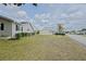 Spacious side yard showcasing the home's siding, manicured bushes, and lawn at 17475 Se 107Th Ct, Summerfield, FL 34491