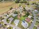 Aerial view of a neighborhood showcases lush landscaping, well-maintained homes, golf course, and cul-de-sac at 17645 Se 117Th Cir, Summerfield, FL 34491