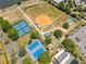 Community aerial view featuring tennis courts and a baseball field perfect for outdoor activities at 17645 Se 117Th Cir, Summerfield, FL 34491