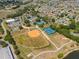 Wide aerial shot of the community showing recreational facilities, homes, and the surrounding area at 17645 Se 117Th Cir, Summerfield, FL 34491